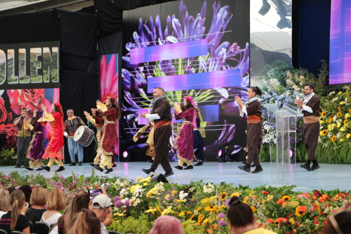 Kurdish dancers dressed in costume and dancing m at the Llangollen Eisteddfod